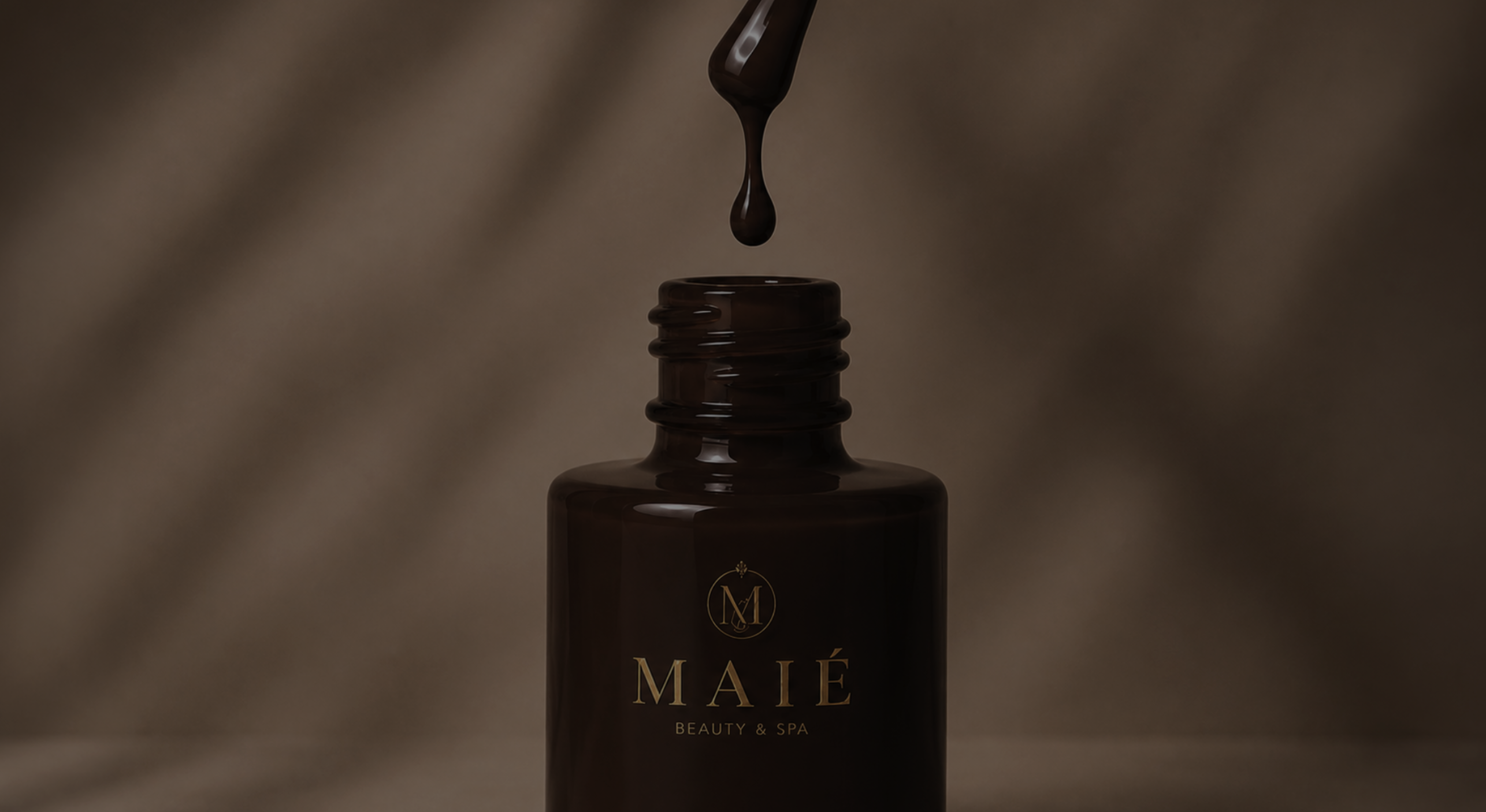 Brown nail polish dripping above an open bottle